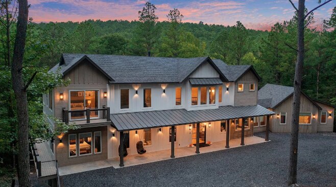 Exterior of the cabin at dusk, nestled in the pines